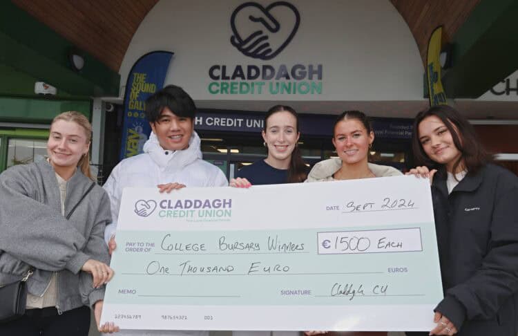 Image of 4 females and 1 male holding cheque for the Unicash bursary.