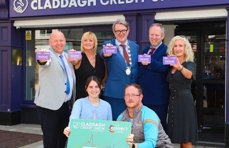 Image of men and women holding Claddagh Credit Union Connect Card.