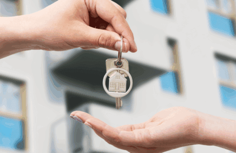 image of hand dropping keys to another hand. Claddagh CU promoting rental scam